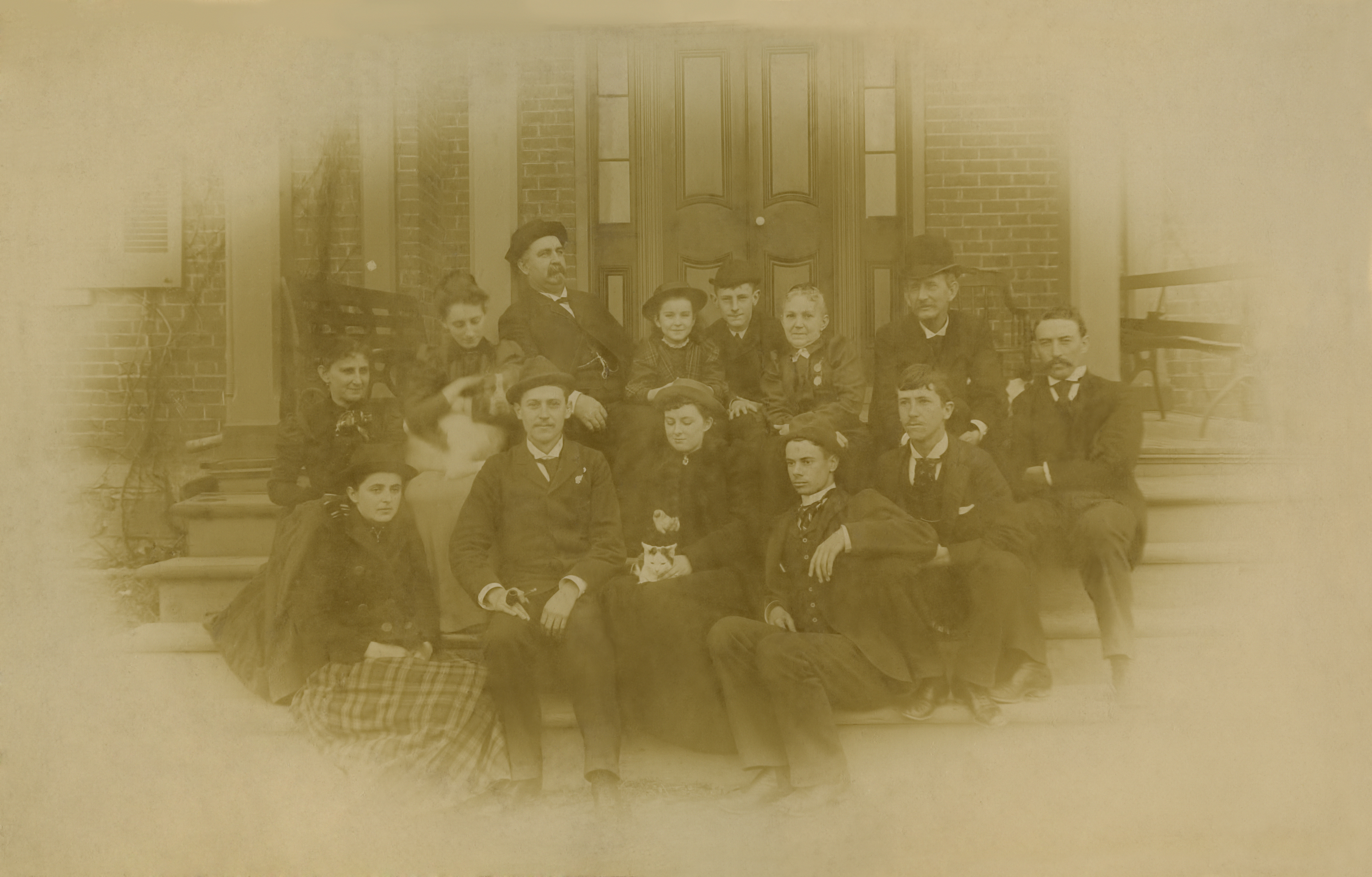 Members of the McBryde and Bolton families sitting on the front steps of the president's house on Christmas