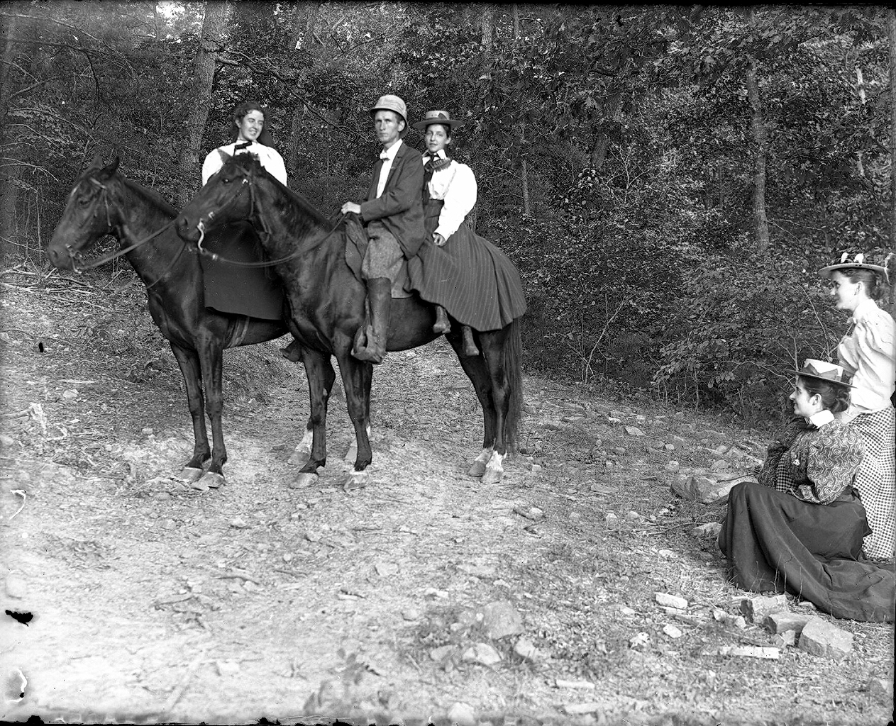 IMage of Susan and John, Jr. on horseback with young lady behind John, Jr. and two other ladies nearby