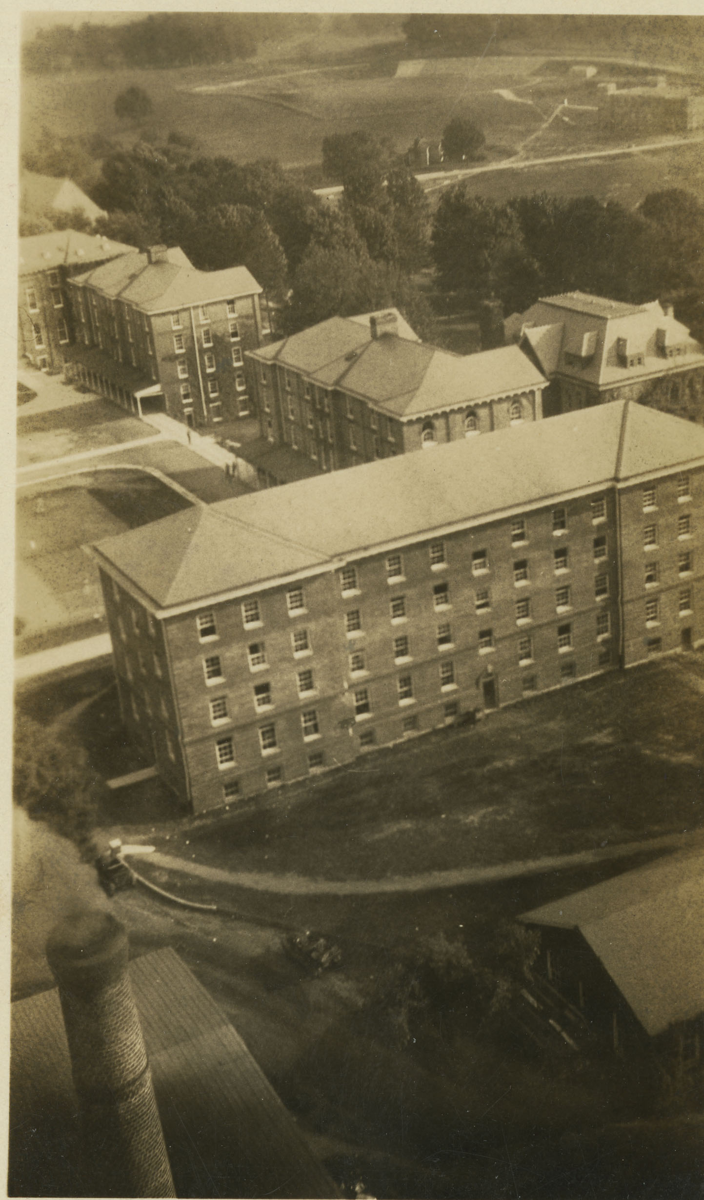 Undated, apparently taken from the smokestack. Barracks No. 6 is at the center, with No. 5 just behind it. To the right of the No. 5 is the old YMCA building. 