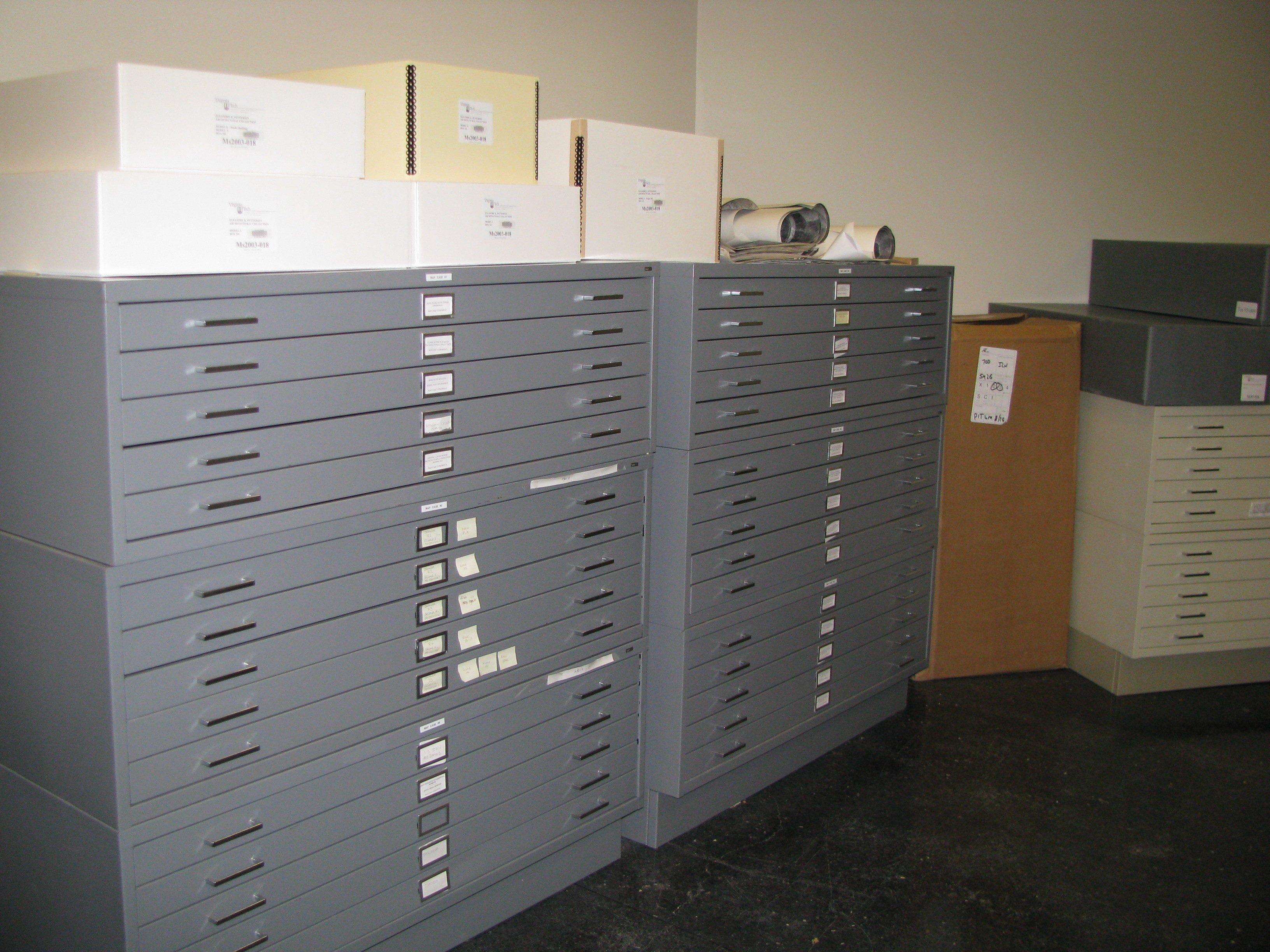 Boxes on top of these map cases contain textiles (while will be moved to new shelving soon) and architectural models.