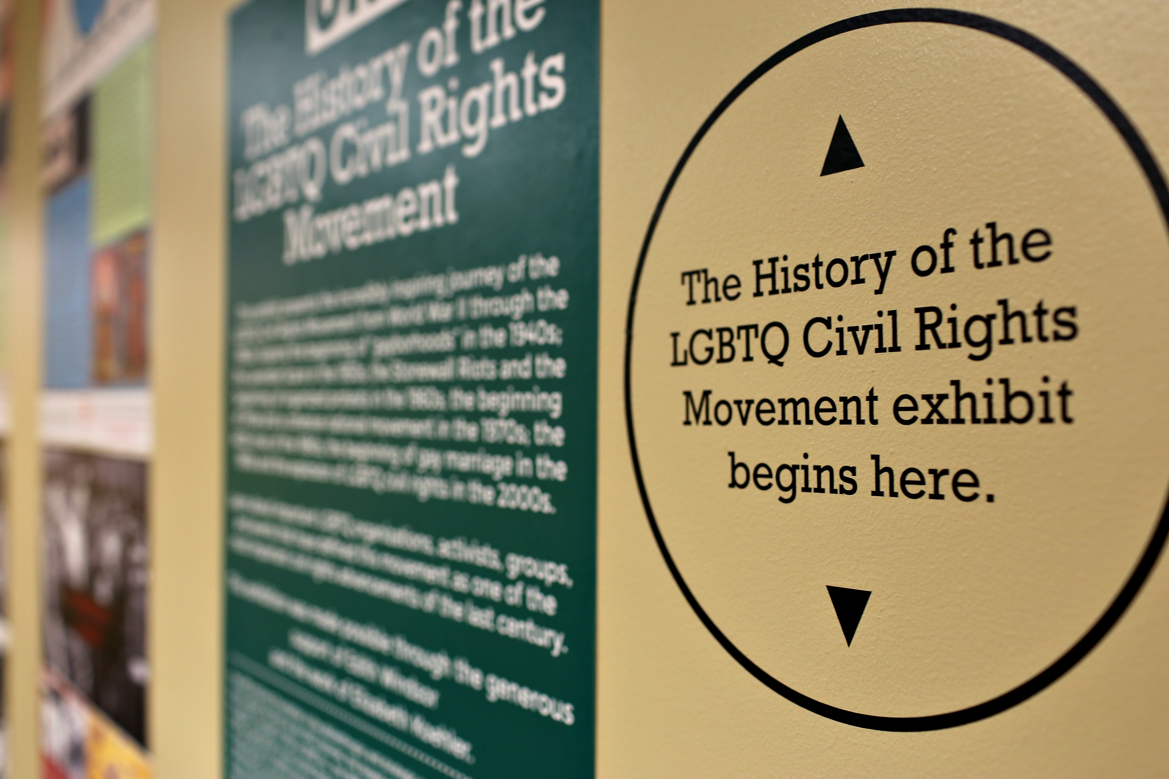 Photograph of a directional sign reading "The History of the LGBTQ Civil Rights Movement exhibit begins here"