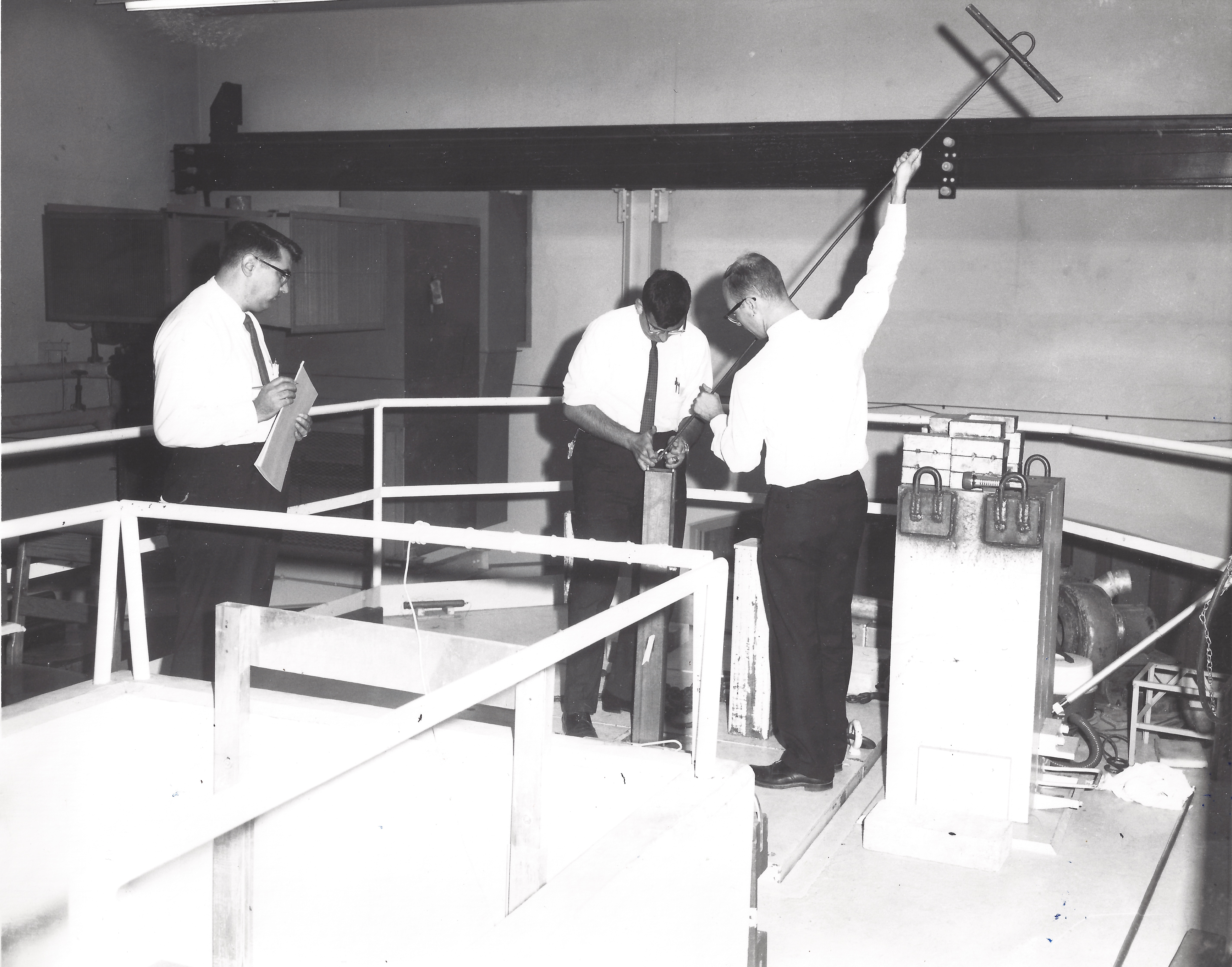 Students working on the Virginia Tech Argonaut Reactor being observed by an instructor, circa 1950s.