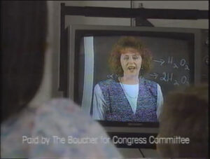 Image of woman of television. Text on screen: Paid by the Boucher for Congress Committee