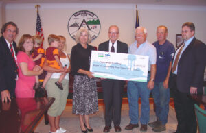 Rick Boucher and group holding a large check.